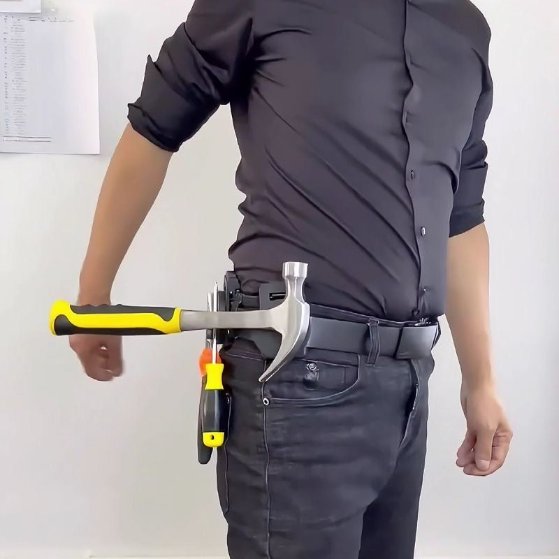 Close-up of a worker's belt showing magnetic tool holder securely gripping a hammer and pliers for hands-free work